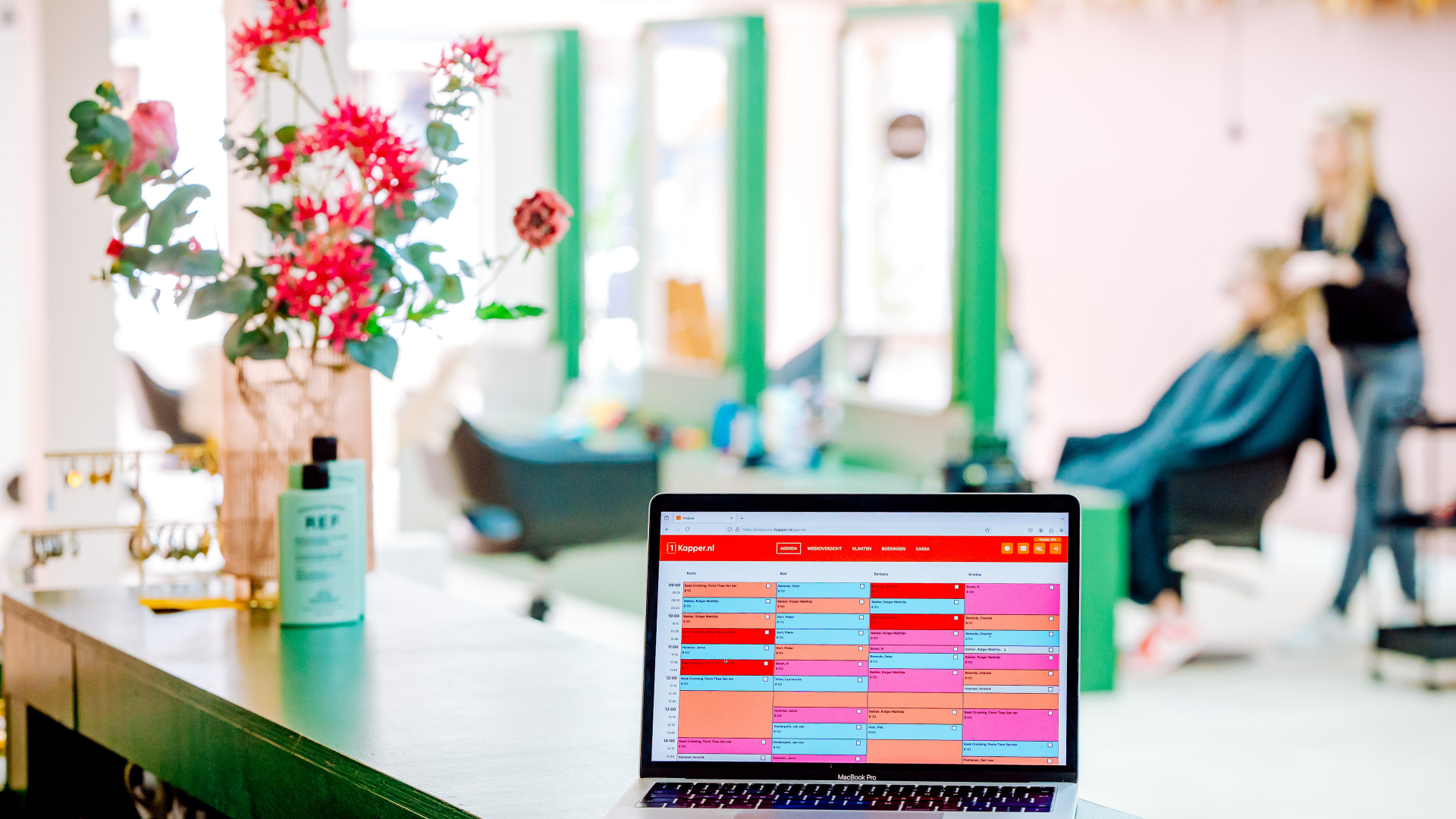 1Kapper.nl online agenda in kapsalon met kapster op achtergrond