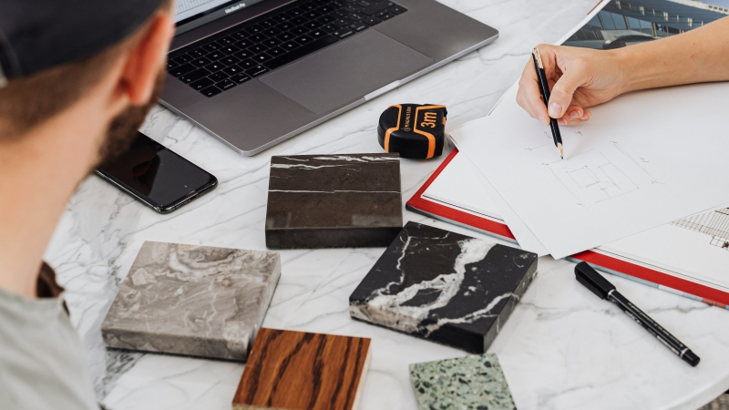 Overwhelmed client surrounded by material samples and design options