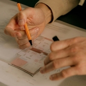 Close-up of an interior designer adjusting material samples and colors on a desk