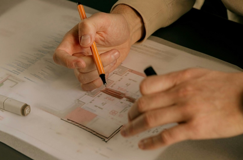Close-up of an interior designer adjusting material samples and colors on a desk