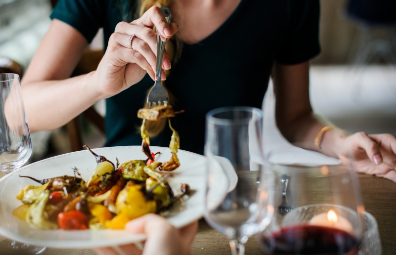 Sitting together at a kitchen table, enjoying a meal and conversation, representing the emotional connection in interior design.