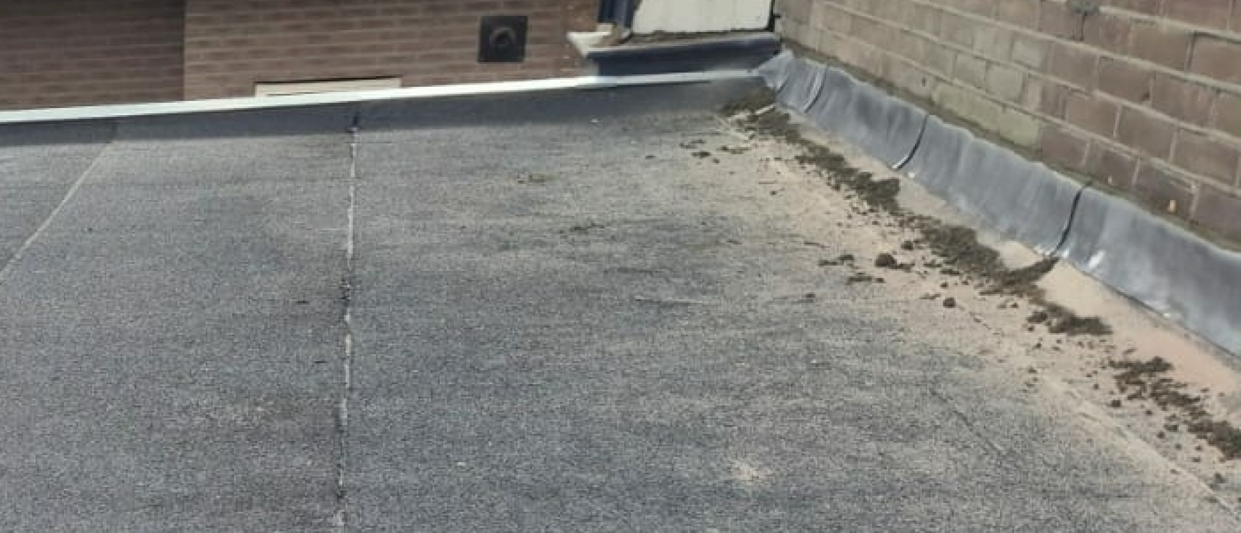 Hoe wordt loodwerk in de spouw aangebracht als we een plat dak aan het vangen zijn?
