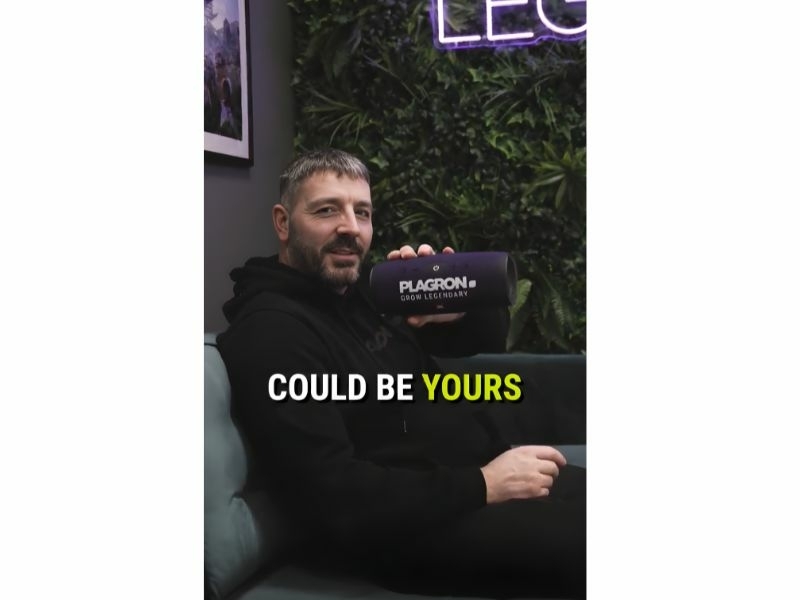 man holding a Plagron branded JBL speaker in his hands