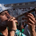 man smoking a thick large joint
