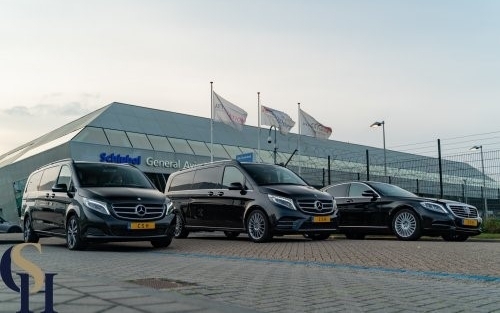 Luxury car service fleet parked outside Schiphol airport.