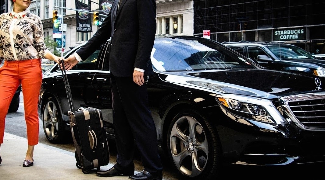 A tourist is using a luxury airport taxi in Amsterdam