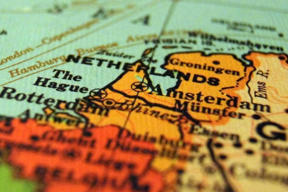 A closeup of a coloured and detailed printed map of the Netherlands