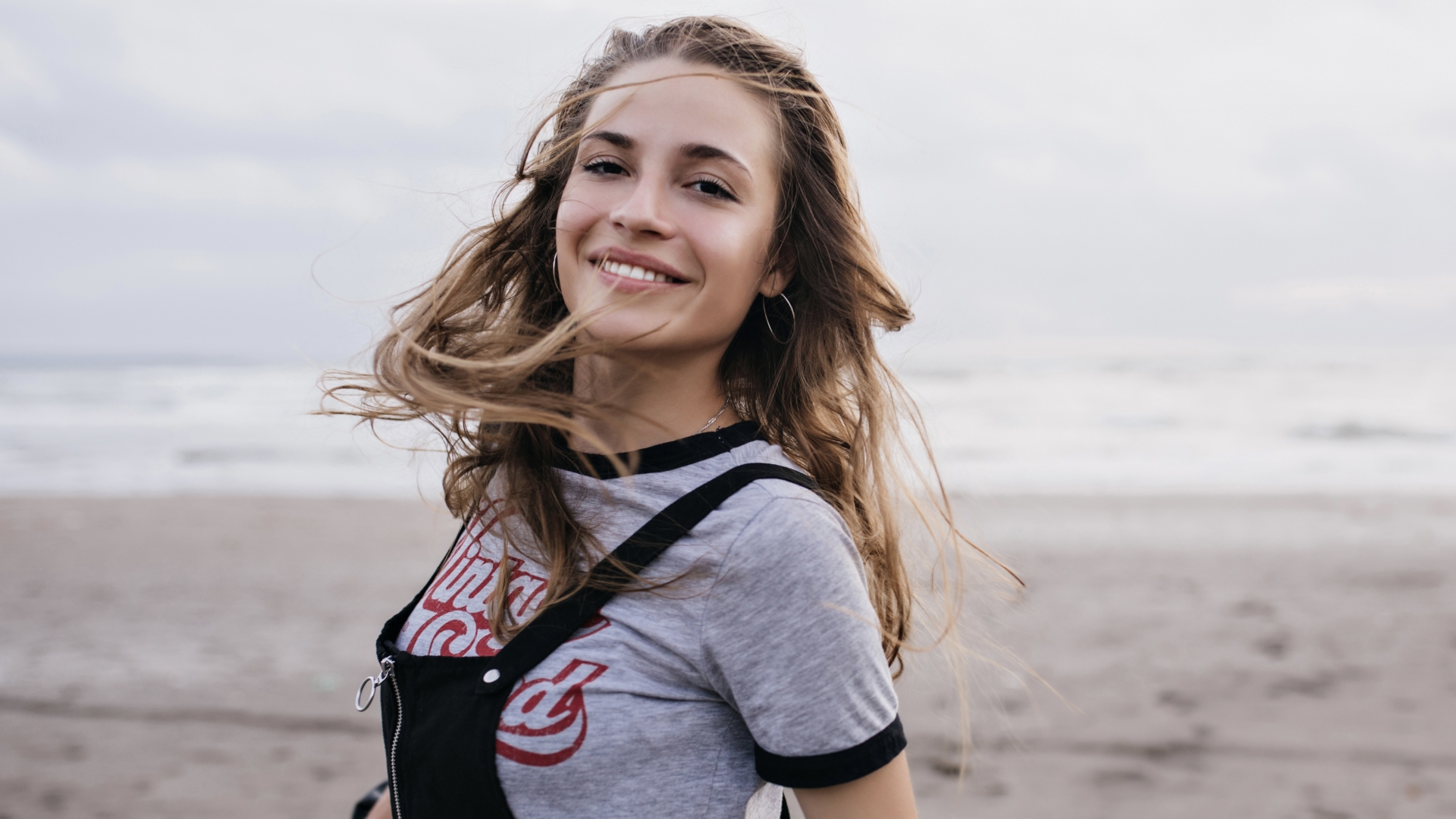 ecstatic-brown-haired-girl-jumping-beach-cloudy-summer-day-photo-attractive-white-female-model-nature