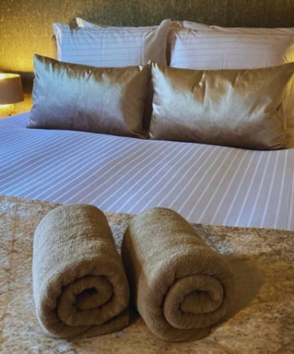 Luxe hotelkamer met opgemaakt bed en zachte handdoeken bij De La Frontière in Slenaken Zuid-Limburg