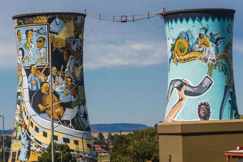 Two  towers with a colorful mural painted on their exteriors.