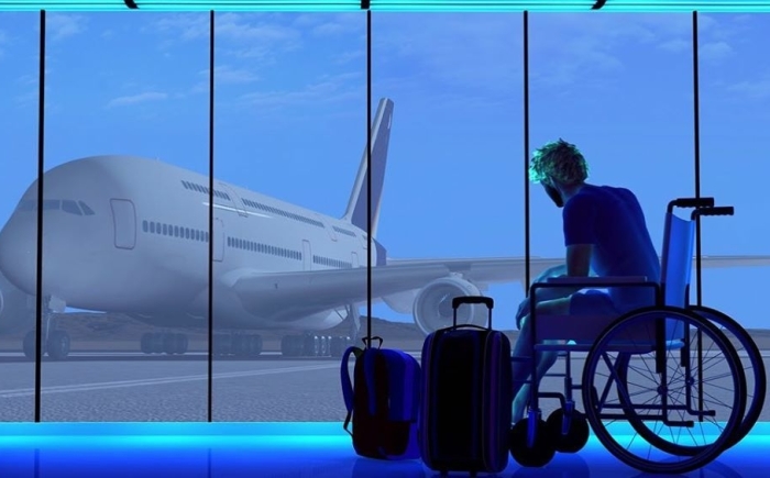Rolstoelgebruiker op een luchthaven kijkt naar vliegtuig