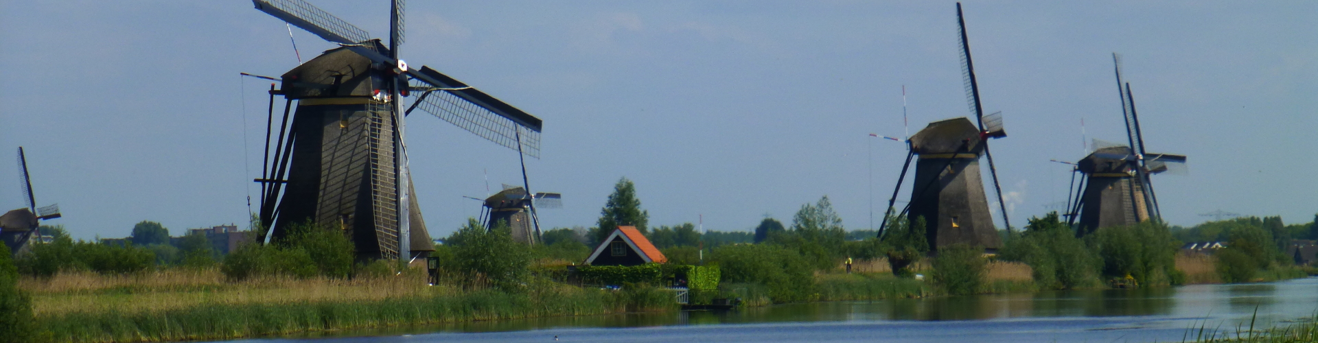 Water pumping windmills in Holland along canal or river
