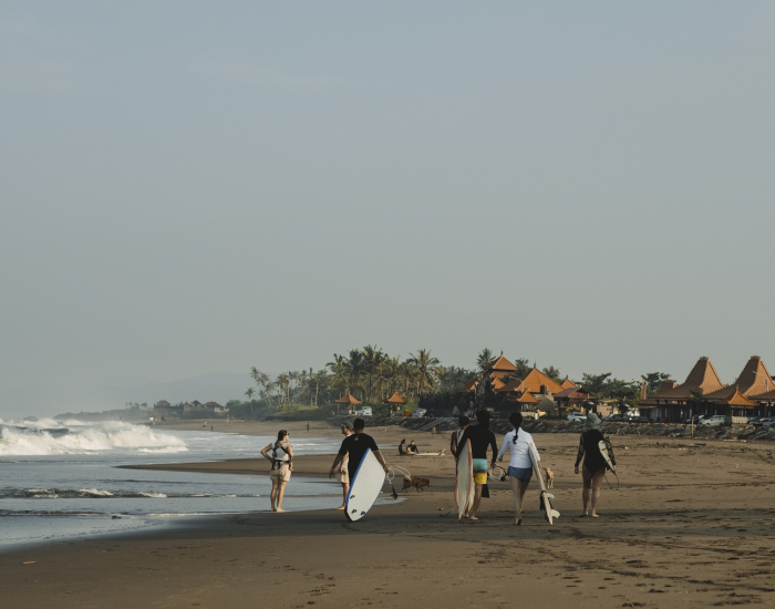 surf retreat guests walking to Kedungu beach with surfboards