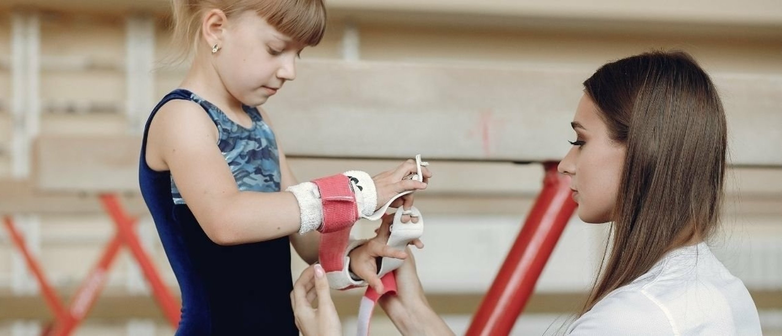 How do you manage assistants during gymnastics training?
