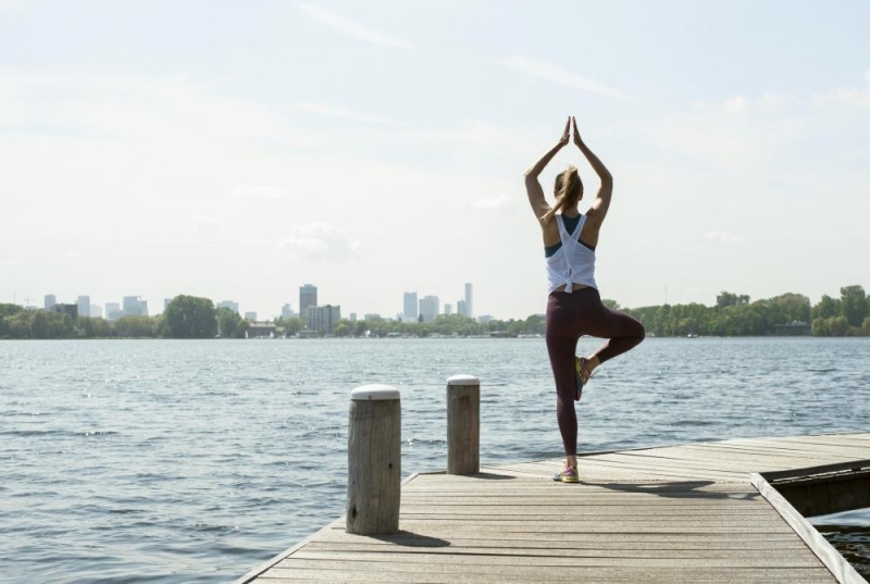 Hollandfit werknemer op de stijger doet een yoga pose