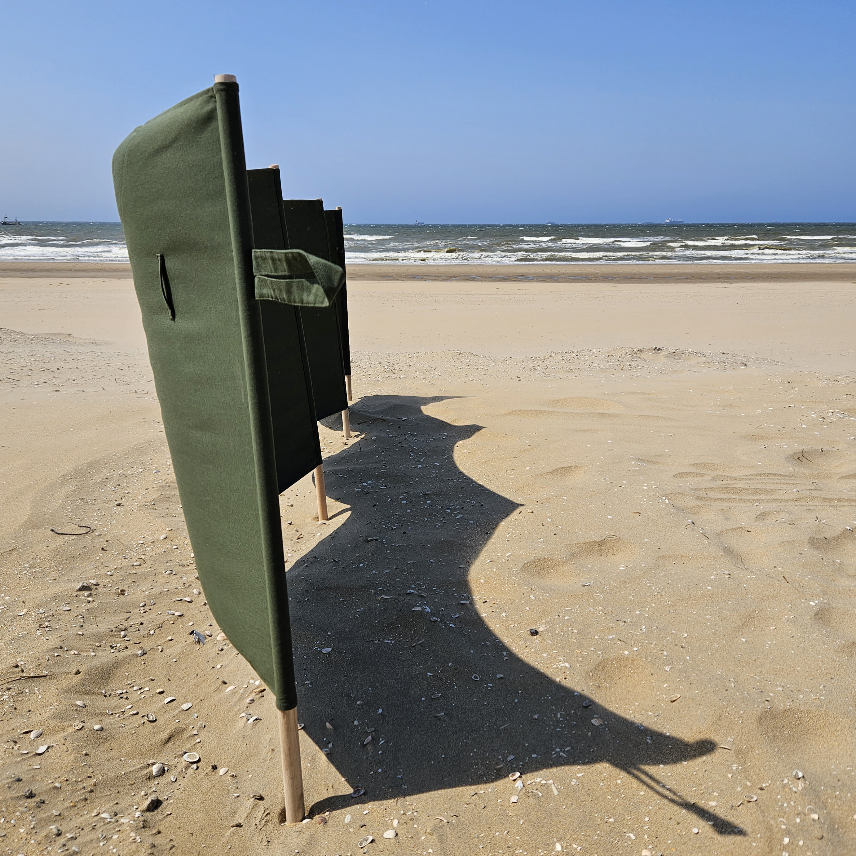 Stoffen windscherm stevig geplaatst in het zand zonder scheerlijnen