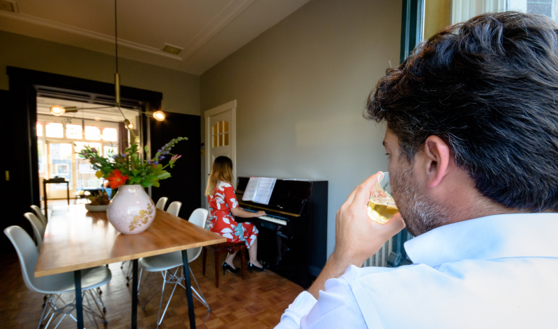 Me enjoying my favorite moment, like having a drink by the window when my wife plays piano