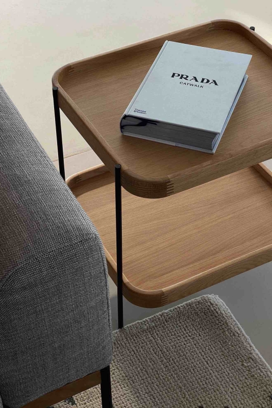 decompressie interieur tips voor woonkamer sidetable van hout met koffietafelboek in minimalistische woonkamer