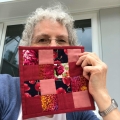 angie-hale-with her quilted coaster made with the nine patch pattern in red and pink fabrics