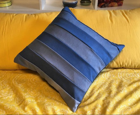 two shades of denim quilted pillow with a striped design by prickly pear quilts. Made from reclaimed fabrics