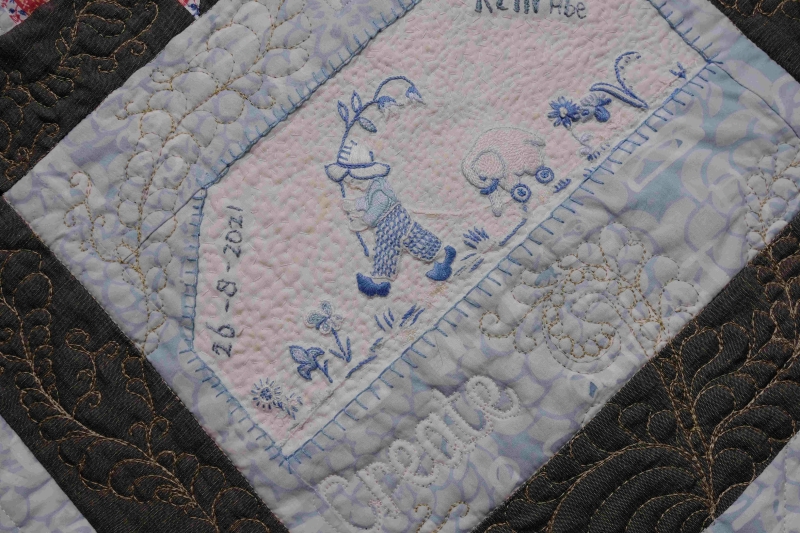 Mother's embroidery used in a memory quilt as a baby quilt gift