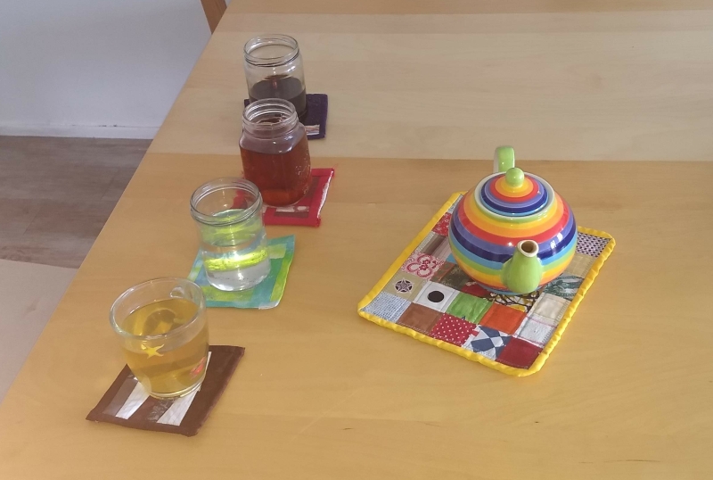4 drinks on quilted  coasters