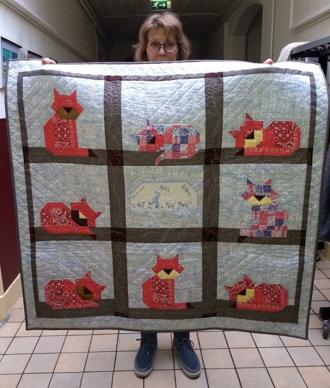 Clasien with Baby memory quilt made from a red farmers handkerchief