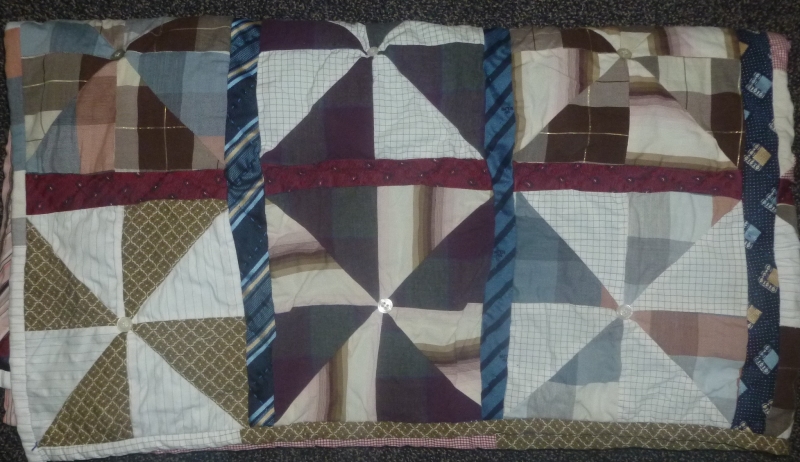 Quilt made with men shirts and ties in brown, red, blue and white colours finishing with tying technique
