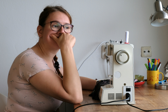 Rianne thinking behind sewing machine