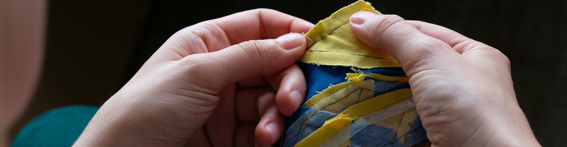 Rianne hand quilting dear jane quilt with foundation piecing and yellow and blue fabric