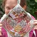 quilted potholder-nikki-shaw made with lessons kick ass quilts college in pink and grey. Quilted with circular lines