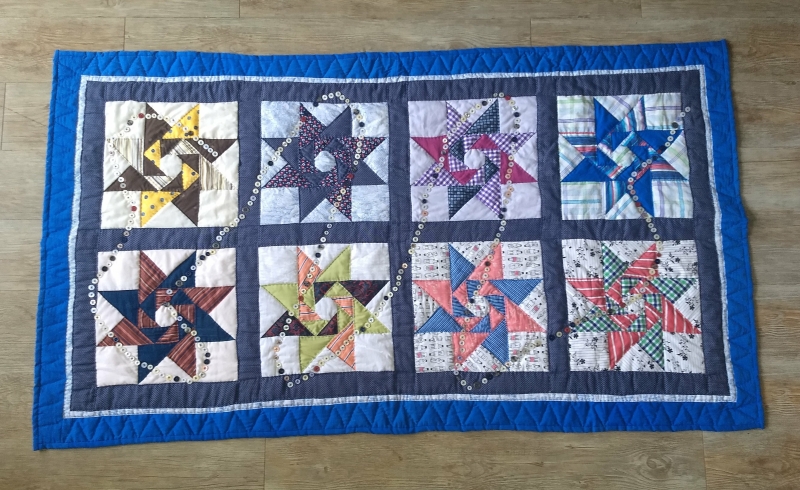 Revolving star quilt with family shirts made by karin. part of the quilt chronicles