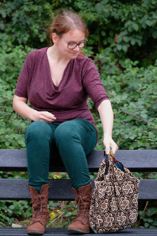 Rianne puts her quilted bag down