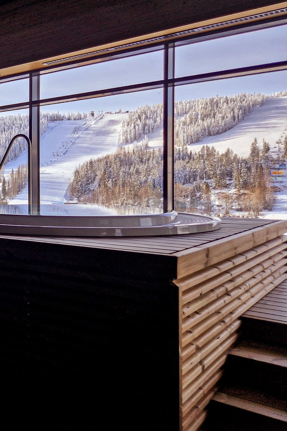 Verwarmd bubbelbad in de wellness van Break Sokos Hotel Tahko met uitzicht op de verlichte skipistes