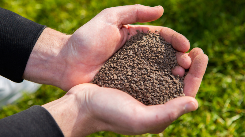 Gazonexpert van MijnGazonCoach met meststoffen voor bodemgericht gazononderhoud