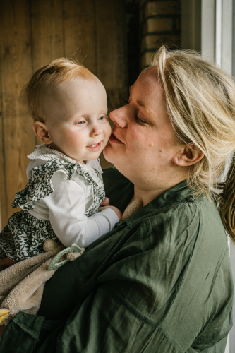 Mom kissing baby