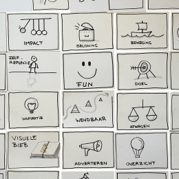 Zelfgetekende symboolkaarten met woorden als vertrouwen, groei en impact uit de Graphic Jam.
