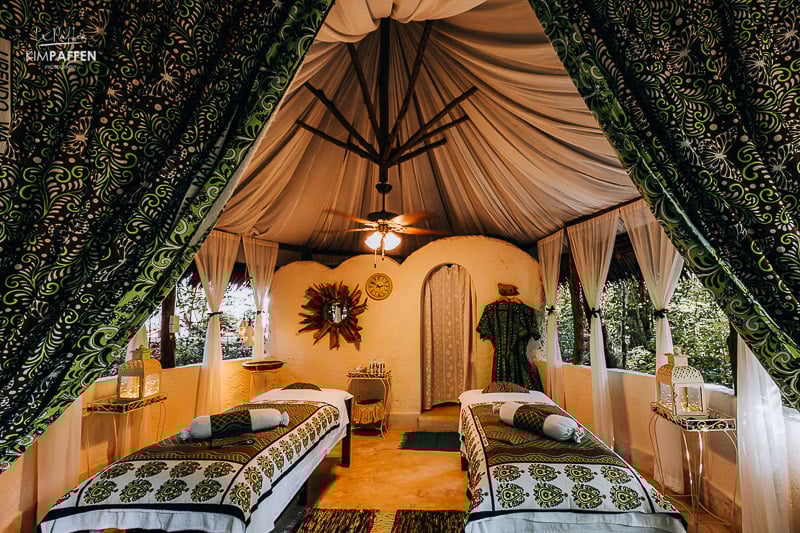 Spa pavilion with massage table in tranquil forest setting