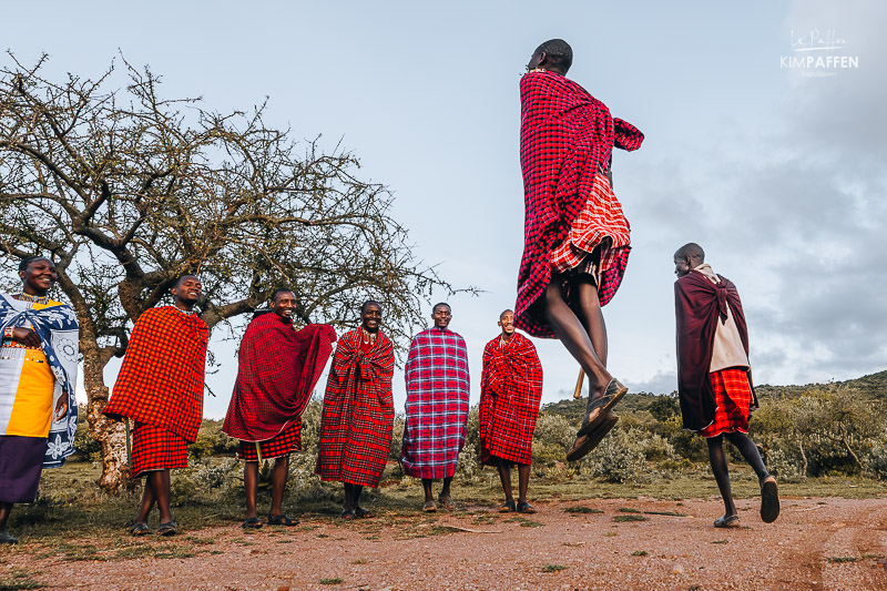 The Maasai Tribe performing a traditional maasai dance wearing colorful shukas at Maji Moto Eco Camp in Kenya
