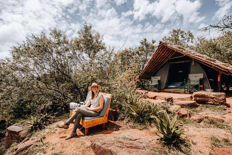 Sitting in front of the basic canvas tent at Maji Moto Eco Camp in Loita Hills Kenya