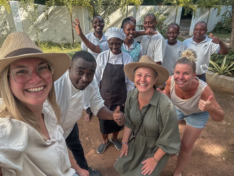 Smiling staff from kitchen, housekeeping, and gardening posing together