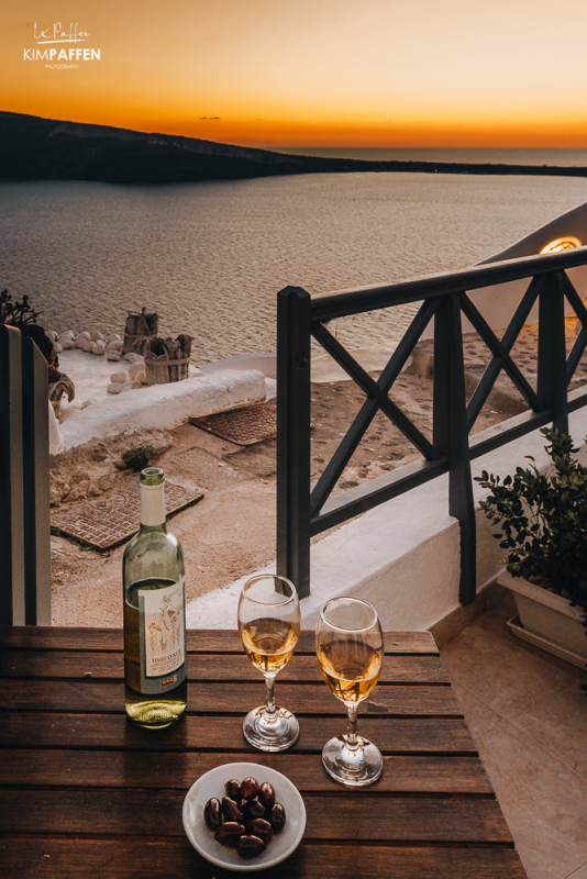 Sunset in Oia Santorini with a glass of wine