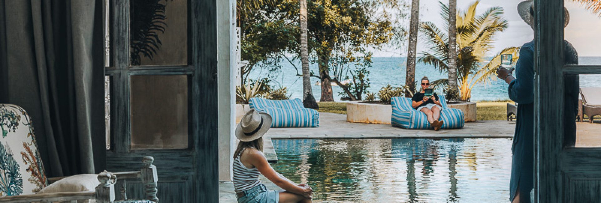 The Sands at Nomad Private Luxury Beach Villa Diani Beach Kenya Sitting at the large swimming pool with views of the ocean at the luxury Fisherman Beachfront Villa at Diani Beach Kenya