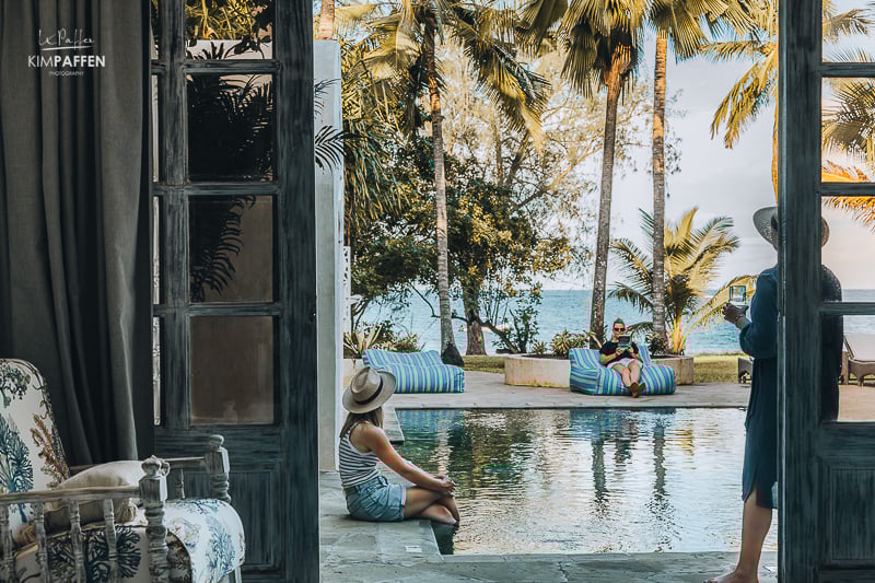 Sitting at the large swimming pool with views of the ocean at the luxury Fisherman Beachfront Villa at Diani Beach Kenya