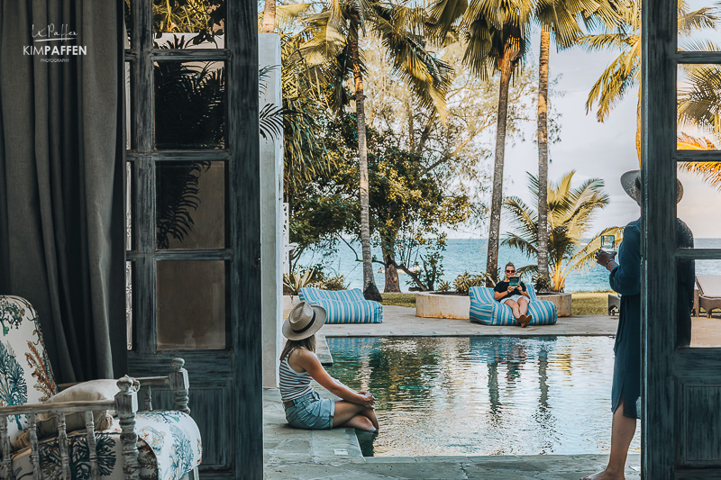 Sitting at the large swimming pool with views of the ocean at the luxury Fisherman Beachfront Villa at Diani Beach Kenya