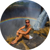 In front of the mighty Victoria Falls in Zambia with a perfect rainbow