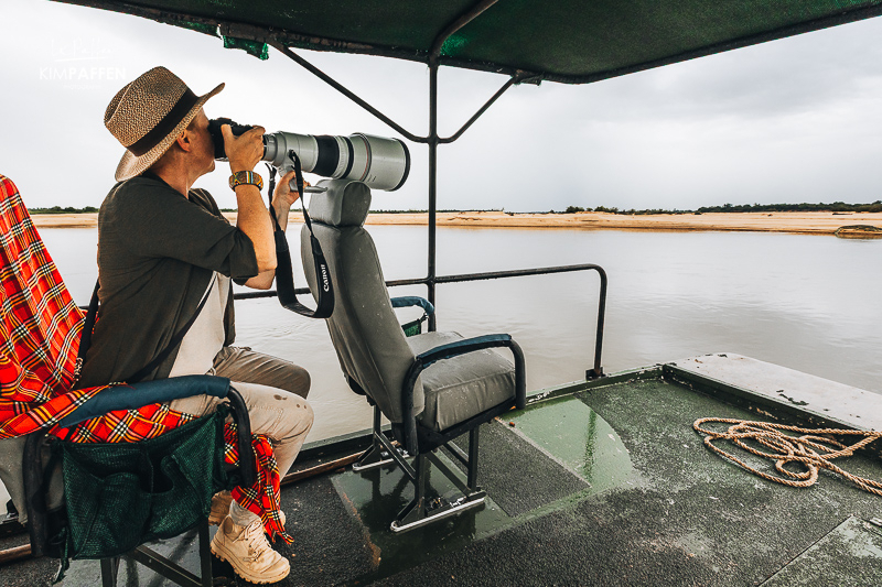 Boat safari on the Rufiji River in Nyerere National Park, with crocodiles along the bank
