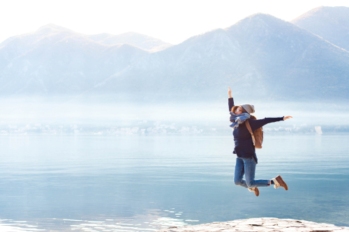 Vrouw die van blijdschap in de lucht springt