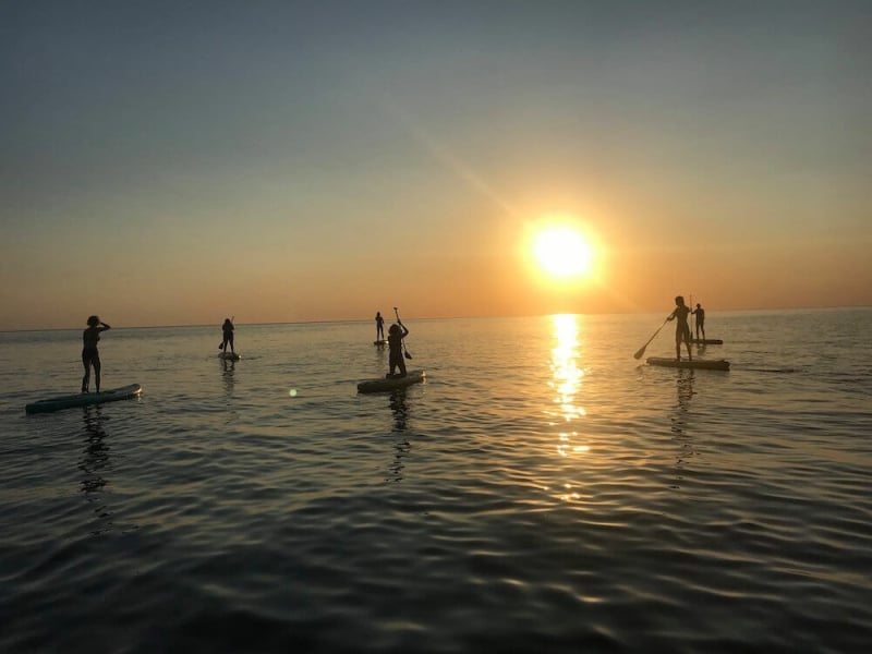 sunset paddle board