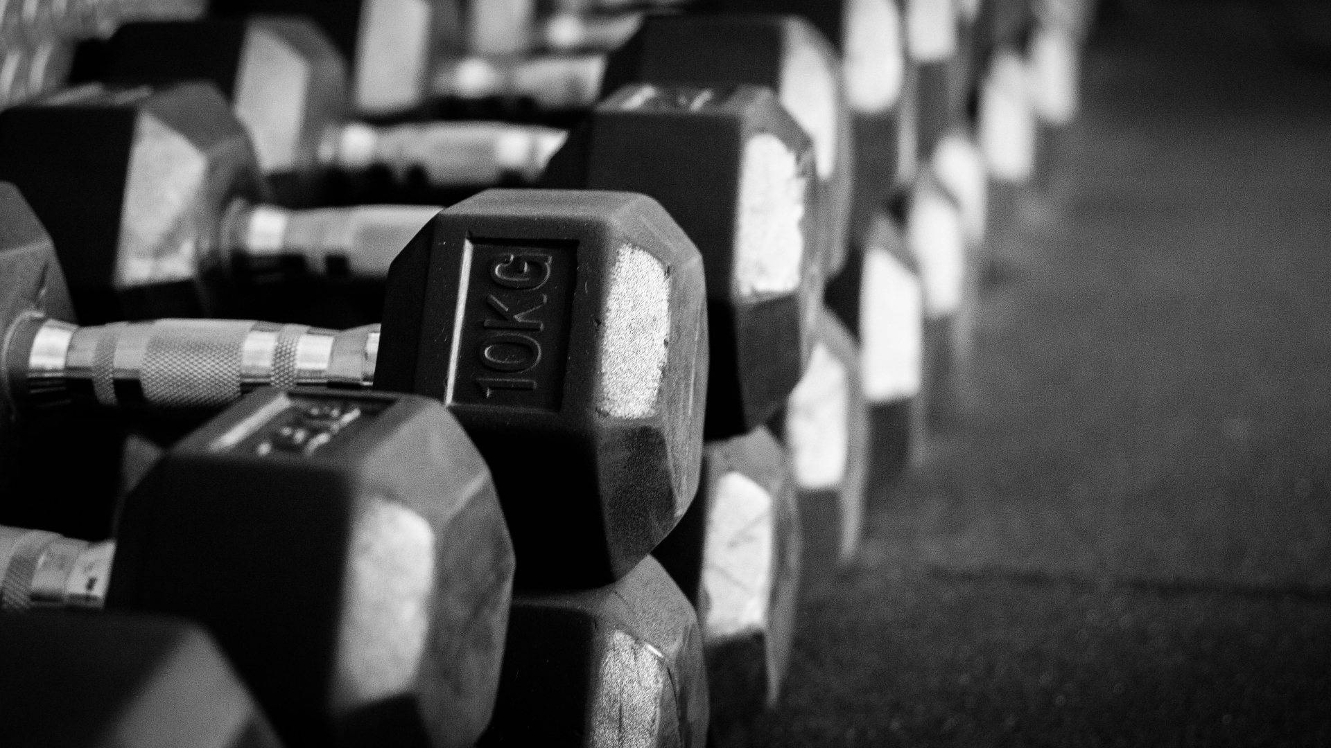 Een zwart wit foto met daarop een set dumbbells